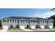Townhome with neat landscaping, a white garage door, blue shutters, and siding of the same color at 2229 Nancy Lee Dr, Lutz, FL 33558
