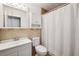 Cozy bathroom with white vanity and matching cabinet above the toilet and shower stall at 2608 W Fletcher Ave, Tampa, FL 33618