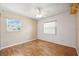 Neutral bedroom with laminate floors, a ceiling fan, and natural light from dual windows at 2608 W Fletcher Ave, Tampa, FL 33618