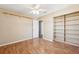 Sunlit bedroom featuring wood laminate floors, closet and ceiling fan with light at 2608 W Fletcher Ave, Tampa, FL 33618