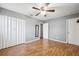 This is a bedroom with light gray walls, wood floor, and ceiling fan at 2608 W Fletcher Ave, Tampa, FL 33618