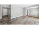 Open-concept living room with wood-look flooring and neutral wall paint at 2608 W Fletcher Ave, Tampa, FL 33618