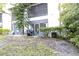 Rear exterior view of property with screened patio and lawn at 3590 Magnolia Ridge Cir # 1103-C, Palm Harbor, FL 34684