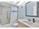Bright bathroom with a shower and tub combination and decorative mirror at 3590 Magnolia Ridge Cir # 1103-C, Palm Harbor, FL 34684