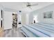 Cozy bedroom with a ceiling fan, closet with shelving, and a large window at 3590 Magnolia Ridge Cir # 1103-C, Palm Harbor, FL 34684