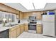 Functional kitchen with stainless steel appliances and natural wood cabinets at 3590 Magnolia Ridge Cir # 1103-C, Palm Harbor, FL 34684