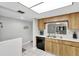 Bright kitchen with wood cabinets, white countertops, stainless steel sink and tile flooring at 3590 Magnolia Ridge Cir # 1103-C, Palm Harbor, FL 34684