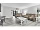 Comfortable living room featuring wood floors, plush seating, and lots of natural light at 3590 Magnolia Ridge Cir # 1103-C, Palm Harbor, FL 34684
