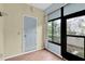 Well-lit sunroom with a door to the outside and wood-look flooring at 3590 Magnolia Ridge Cir # 1103-C, Palm Harbor, FL 34684