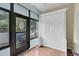 Convertible sunroom featuring Murphy bed and outdoor access with wooded view at 3590 Magnolia Ridge Cir # 1103-C, Palm Harbor, FL 34684