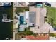 Aerial view of a waterfront home featuring a swimming pool, dock, and lush landscaping at 3616 Harborview Ct, New Port Richey, FL 34652