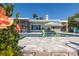Backyard pool with screen porch and covered patio, surrounded by lush landscaping at 3616 Harborview Ct, New Port Richey, FL 34652