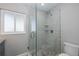 Modern bathroom with mosaic tile shower, glass enclosure, and geometric patterned tile accent at 3616 Harborview Ct, New Port Richey, FL 34652