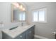 Bathroom featuring a window, sink, vanity and decorative mirror with nautical decor at 3616 Harborview Ct, New Port Richey, FL 34652