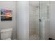 Modern bathroom with mosaic tile shower, glass enclosure, and gray patterned tile accent at 3616 Harborview Ct, New Port Richey, FL 34652