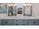 Bathroom showcasing double vanity with granite countertop, modern fixtures, and decorative mirrors at 3616 Harborview Ct, New Port Richey, FL 34652