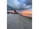 Beautiful beach view at sunset with colorful skies, palm trees, and calm water at 3616 Harborview Ct, New Port Richey, FL 34652