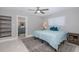 Bright bedroom with ceiling fan, plush carpet, and en suite bath with gray vanity at 3616 Harborview Ct, New Port Richey, FL 34652