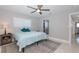 Bedroom featuring ceiling fan, natural light, and easy access to closet and en suite bath at 3616 Harborview Ct, New Port Richey, FL 34652