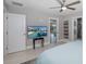 Bedroom with en suite bath, walk-in closet, and TV with view of swimming pool outside at 3616 Harborview Ct, New Port Richey, FL 34652