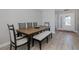 Bright dining room features wood flooring, a wooden table, seating bench and chairs for a comfortable space at 3616 Harborview Ct, New Port Richey, FL 34652