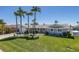 Picture of a single-story home with a lush green lawn, mature palm trees, and an attached garage at 3616 Harborview Ct, New Port Richey, FL 34652
