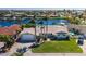 Waterfront home with lush landscaping, tile roof, and private boat dock on a sunny day at 3616 Harborview Ct, New Port Richey, FL 34652