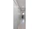 Hallway featuring multiple closets, overhead lights and a peek at the room down the hall at 3616 Harborview Ct, New Port Richey, FL 34652