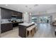 Beautiful kitchen featuring an island with bar stools, stainless steel appliances, and views of the backyard at 3616 Harborview Ct, New Port Richey, FL 34652