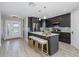 Modern kitchen boasts an island with bar seating, stainless steel appliances, and stylish cabinetry at 3616 Harborview Ct, New Port Richey, FL 34652