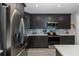 Gorgeous kitchen with stainless steel appliances, quartz countertop and dark cabinetry at 3616 Harborview Ct, New Port Richey, FL 34652