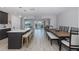 Open-concept kitchen and dining area with an island, bar stools and seating for a functional space at 3616 Harborview Ct, New Port Richey, FL 34652