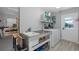 Functional laundry room with utility sink, washer, dryer, and shelving for storage at 3616 Harborview Ct, New Port Richey, FL 34652