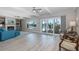 Spacious living room with a fireplace, large windows, and seating area, offering natural light and space at 3616 Harborview Ct, New Port Richey, FL 34652