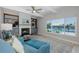 Relaxing living room includes a fireplace, plush seating, and a large window overlooking the pool at 3616 Harborview Ct, New Port Richey, FL 34652
