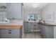Bright office area with grey cabinets, wood countertop, and natural light from the window at 3616 Harborview Ct, New Port Richey, FL 34652