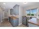 Bright office area with grey cabinets, wood countertop, and natural light from the window at 3616 Harborview Ct, New Port Richey, FL 34652
