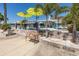 Outdoor patio with dining table and lounge chairs, perfect for entertaining or relaxing by the water at 3616 Harborview Ct, New Port Richey, FL 34652