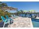 Gorgeous waterfront pool with lounge chairs, patio umbrella, and outdoor bar seating overlooking the water at 3616 Harborview Ct, New Port Richey, FL 34652