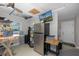 Functional utility room with stainless steel refrigerator, storage, and a mounted television at 3616 Harborview Ct, New Port Richey, FL 34652