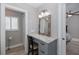 Bathroom vanity featuring a granite countertop, drawers, and vanity mirror with wall lighting at 3616 Harborview Ct, New Port Richey, FL 34652