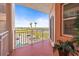 Balcony with steel railing and red painted floor has beautiful water views and palm trees at 4516 Seagull Dr # 408, New Port Richey, FL 34652