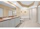Bathroom with double vanity, soaking tub, and glass-enclosed shower at 4516 Seagull Dr # 408, New Port Richey, FL 34652