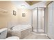 Bathroom featuring a soaking tub and separate glass shower at 4516 Seagull Dr # 408, New Port Richey, FL 34652
