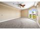 Bright carpeted bedroom featuring large window overlooking waterfront at 4516 Seagull Dr # 408, New Port Richey, FL 34652