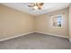 This bedroom has neutral walls, carpet, and a large window letting in natural light at 4516 Seagull Dr # 408, New Port Richey, FL 34652