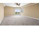 Bright bedroom features carpet, neutral paint, sliding glass doors to balcony, and a modern ceiling fan at 4516 Seagull Dr # 408, New Port Richey, FL 34652