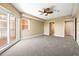 Spacious carpeted bedroom with ceiling fan and sliding glass doors to a balcony at 4516 Seagull Dr # 408, New Port Richey, FL 34652