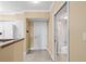 Entryway features tile flooring, beige walls, and white trim with an entrance to the bathroom and kitchen at 4516 Seagull Dr # 408, New Port Richey, FL 34652