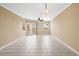Bright living room features tile floors, neutral paint, sliding glass doors to balcony, and a contemporary light fixture at 4516 Seagull Dr # 408, New Port Richey, FL 34652